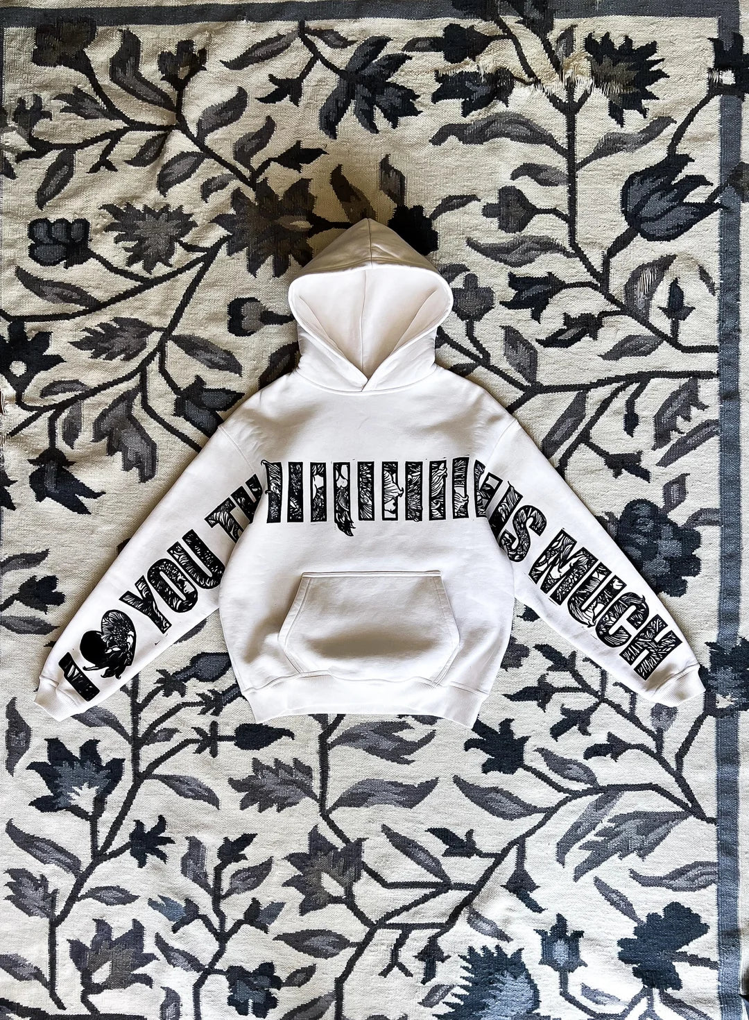 Model wearing I Love You This Much white oversized graphic streetwear hoodie by Section Zero